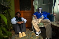 two men sitting in a chair